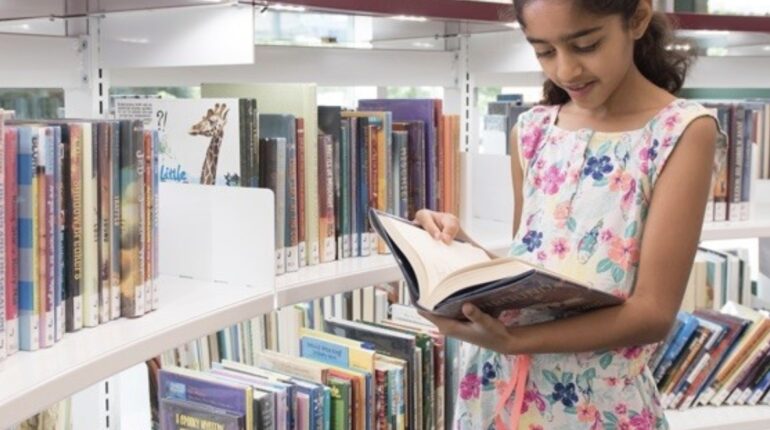 school aged child reading book